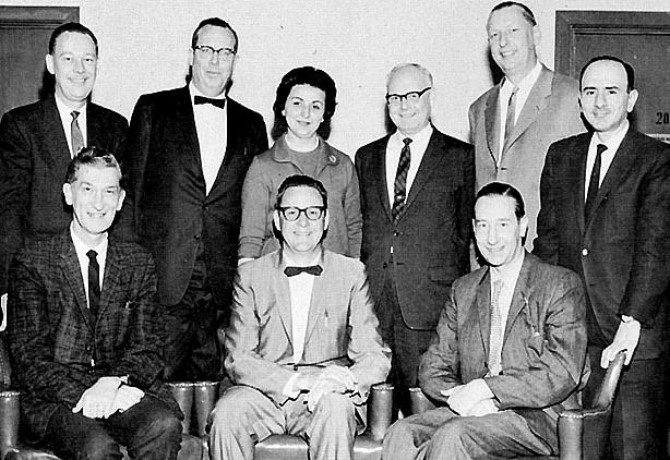 The staff that produced the Doug Pledger Show on KNBC Radio (680 AM in San Francisco) in the 1950s. Seated, left to right: Clarence Leisure, announcer; Doug Pledger, program host; John Grover, announcer. Standing, left to right: Budd Heyde, announcer; Jack Van Wart, engineer; Enka Pledger (Mrs. Doug Pledger); Oscar Berg, engineer; Lee Kolm, engineering supervisor; Shahan Alexanian, engineer.