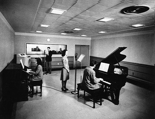 NBC Studio with two pianos and a woman standing at a microphone