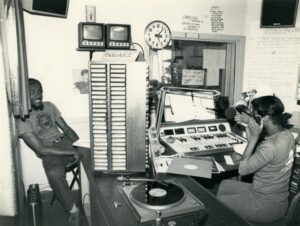 Unidentified people in studio of KRE, 1980's. Image from African American Museum & Library at Oakland