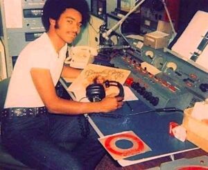 Rick Batiste in KNBA studio, 1974